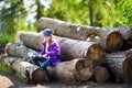 Cute little girl using a pocket knife to whittle a stick for a forest hike Royalty Free Stock Photo