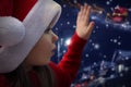 Cute little girl waiting for Santa Claus, closeup. Christmas celebration Royalty Free Stock Photo