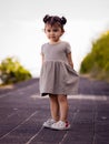 Cute little girl walking along the promenade near the beach. Warm sunny day. Summer vacation. Holiday concept. Baby girl wearing Royalty Free Stock Photo