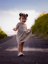Cute little girl walking along the promenade near the beach. Warm sunny day. Summer vacation. Holiday concept. Baby girl wearing Royalty Free Stock Photo