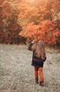 Cute little girl walking in autumn forest