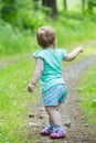 Cute Little girl walking away on the road ahead Royalty Free Stock Photo