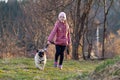 A cute little girl walks a dog - a pug. Happy puppy and owner Royalty Free Stock Photo