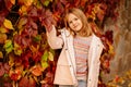 cute little girl by wall with autumn wild grapes. beauty of autumn nature. Royalty Free Stock Photo