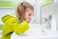 Cute little girl washing face in bath Royalty Free Stock Photo