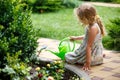 Cute little girl watering plants in the garden. Royalty Free Stock Photo