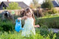 Cute little girl watering plants in the garden Royalty Free Stock Photo