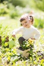 Cute little girl watering plants with watering can in the garden. Royalty Free Stock Photo