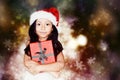 Cute little girl wear santa hat and hold a gift box Royalty Free Stock Photo