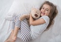 Cute little girl in bed with soft toy