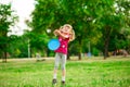 Cute little girl in white bows hold telephone and take picture on red backgroundLittle girl play with flying disk in motion