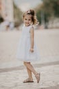 Cute little girl in white dress, posing and smiling Royalty Free Stock Photo