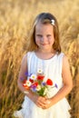 Cute little girl with wild flowers red poppy bouquet Royalty Free Stock Photo