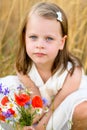 Cute little girl with wild flowers red poppy bouquet Royalty Free Stock Photo