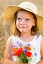 Cute little girl with wild flowers red poppy bouquet Royalty Free Stock Photo