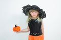 Cute little girl in witch costume with pumpkins. Halloween. On a white background. Royalty Free Stock Photo
