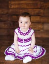 Cute little girl on a wooden background. Royalty Free Stock Photo