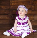 Cute little girl on a wooden background. Royalty Free Stock Photo