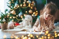 Cute little girl writing a letter to Santa Claus Royalty Free Stock Photo