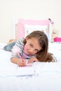 Cute Little girl writing on a notebook Royalty Free Stock Photo