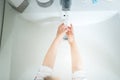 Cute little girl 2-3 years old washing hands with soap and water in bright bathroom. Top view Royalty Free Stock Photo