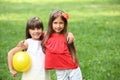 Cute little girls with ball in park on summer day