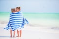 Little cute girls wrapped in towel at tropical beach. Kids on the beach vacation Royalty Free Stock Photo