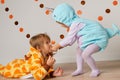 Cute little girls in giraffe and narwhal costume play at home. Halloween party
