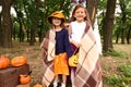 Cute little girls with Halloween pumpkins in autumn park Royalty Free Stock Photo