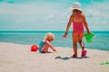 Cute little girls play with sand on summer beach Royalty Free Stock Photo