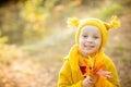 Cute little girls with big bue eyes playing on beautiful autumn day. Happy children having fun in autumn park. The girl Royalty Free Stock Photo