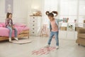 Cute little girls playing hopscotch at home Royalty Free Stock Photo