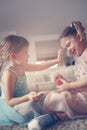 Cute little girls playing with make up in the room. Royalty Free Stock Photo