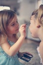 Cute little girls playing with make up in the room. Royalty Free Stock Photo