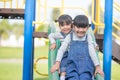 Cute little girls siblings having fun on playground outdoors on a sunny summer day. active sport leisure for kids Royalty Free Stock Photo