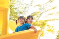 Cute little girls siblings having fun on playground outdoors on sunny summer day. Children on plastic slide. Fun activity for kid Royalty Free Stock Photo