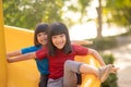 Cute little girls siblings having fun on playground outdoors on sunny summer day. Children on plastic slide. Fun activity for kid Royalty Free Stock Photo