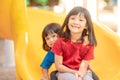 Cute little girls siblings having fun on playground outdoors on sunny summer day. Children on plastic slide. Fun activity for kid Royalty Free Stock Photo