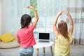 Cute little girls taking online dance class, back view Royalty Free Stock Photo