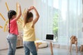 Cute little girls taking online dance class, back view Royalty Free Stock Photo