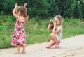 Cute little girls taking pictures with old film camera outdoor.  Pretty children in nature Royalty Free Stock Photo