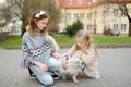 Cute little girls with their cat on sunny spring day. Adorable children holding their pet kitty Royalty Free Stock Photo