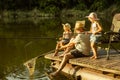Cute little girls and their granddad are on fishing at the lake or river Royalty Free Stock Photo