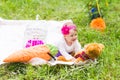 Cute little happy baby girl with big brown teddy bear on green grass meadow, spring or summer season Royalty Free Stock Photo