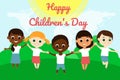 Cute little happy children of different nationalities stand on the green grass under the blue sky and hold hands. Royalty Free Stock Photo