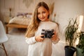 Cute Little Happy Girl With Vintage Photo Camera in a bright room Royalty Free Stock Photo