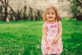 Cute little happy toddler girl portrait walking in spring or summer park Royalty Free Stock Photo