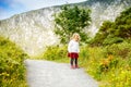 Cute little happy toddler girl running on nature path in Glenveagh national park in Ireland. Smiling and laughing baby Royalty Free Stock Photo