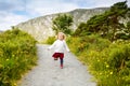 Cute little happy toddler girl running on nature path in Glenveagh national park in Ireland. Smiling and laughing baby Royalty Free Stock Photo