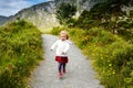 Cute little happy toddler girl running on nature path in Glenveagh national park in Ireland. Smiling and laughing baby Royalty Free Stock Photo